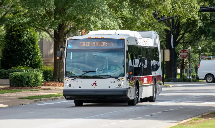 a bus drives through campus